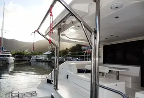 2018 Leopard 43 Powercat docked at a marina with scenic mountain backdrop.
