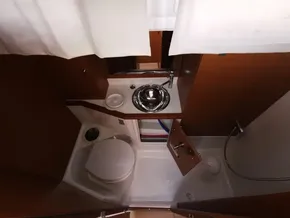 Compact bathroom in 2019 Jeanneau Sun Odyssey 389 yacht, featuring toilet, sink, and shower.