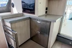 Modern kitchen area on a 2017 Leopard 48 yacht with stainless steel appliances.