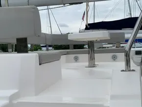 Leopard 45 catamaran deck with seating and table, 2021 model, marina background.
