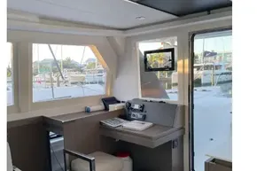 Modern interior of 2022 Leopard 42 yacht with navigation station and large windows.