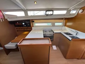Interior of 2019 Jeanneau Sun Odyssey 440 yacht, featuring modern kitchen and dining area.