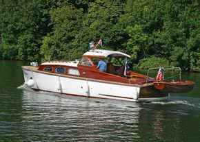 Varnished dinghy on chrome davits