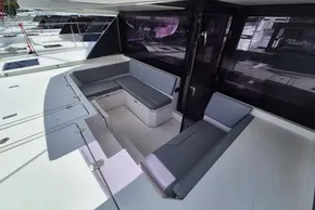 Outdoor seating area on a 2021 Leopard 45 catamaran, featuring modern gray cushions.