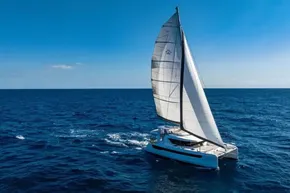 Sailing Leopard 46 catamaran on open sea under clear blue sky, 2025 model.