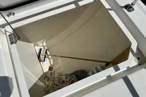 Storage compartment of 2025 Robertson and Caine Leopard 46 Powercat with rope and cleaning brush.