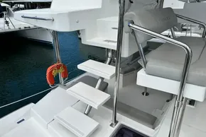 Stairs and seating area on a 2021 Leopard 50 yacht, docked at a marina.