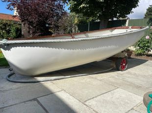 Yacht tender with sail, oars, trolley