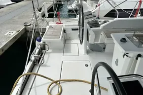 2023 Beneteau Oceanis 51.1 yacht deck with steering wheel and dock view.