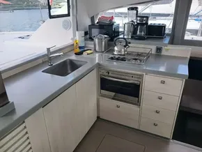 Modern kitchen in a 2021 Leopard 40 catamaran with appliances and sleek countertops.