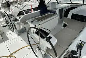 2023 Beneteau Oceanis 51.1 yacht cockpit with dual steering wheels and spacious seating.