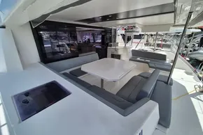 Spacious outdoor seating area on a 2021 Leopard 45 catamaran, featuring a modern dining table.