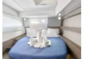 Luxurious cabin interior of 2021 Leopard 50 yacht with elegant bedding and modern design.