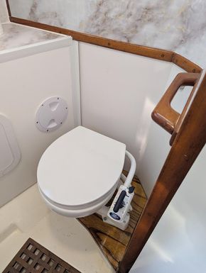 Brand new full size toilet in reconditioned large bathroom heads with shower tray and electric water pump drainage