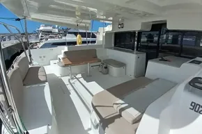 2020 Lagoon 46 yacht deck with seating and table, docked at marina.