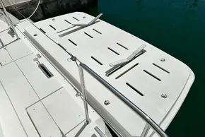 2022 Leopard 53 Powercat swim platform with cleats and railing, docked in clear water.