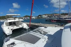 2020 Lagoon 46 catamaran docked in a sunny marina with clear blue skies.