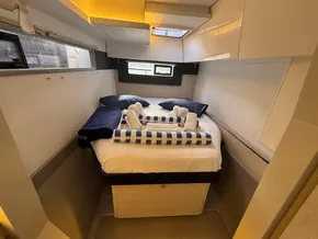 Luxurious cabin interior of a 2019 Leopard 40 yacht with neatly arranged bedding.