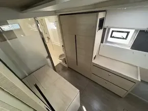 Modern interior of 2020 Leopard 50 yacht with wood finish and ample storage.