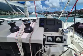 Helm of 2021 Leopard 45 catamaran in marina, featuring navigation instruments and winches.