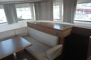 Interior of 2020 Lagoon 46 yacht with seating and windows.