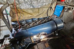 Engine room of a 1927 Classic Dutch Barge, featuring a vintage blue engine.