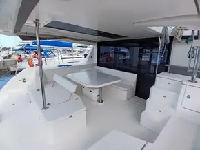 Spacious deck of 2019 Leopard 45 catamaran with seating and table.
