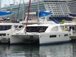 2021 Leopard 40 catamaran docked at marina with cruise ship in background.