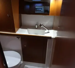 2019 Beneteau Oceanis 41.1 yacht bathroom with sink, mirror, and toilet.