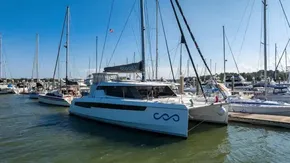 2022 Leopard 50 catamaran docked at marina under clear blue sky.