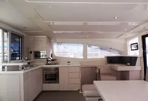 Modern kitchen and dining area inside a 2015 Leopard 51 Powercat yacht.