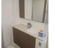 Modern bathroom in 2022 Leopard 45 yacht with sleek fixtures and mirrored cabinet.