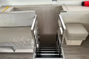 Interior of 2021 Leopard 50 yacht with modern seating and sleek metal staircase.