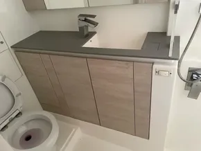 Modern bathroom with wooden cabinets, sleek faucet, and toilet in a Leopard 50 yacht, 2020 model.