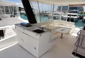 Leopard 43 Powercat 2017 yacht interior with seating area, kitchenette, and marina view.