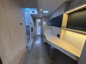 Modern interior of 2019 Leopard 40 catamaran with sleek wood finishes and ambient lighting.