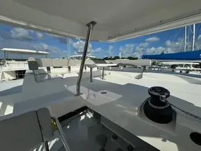 Leopard 50 yacht deck, 2020 model, featuring spacious seating and winch under a clear blue sky.