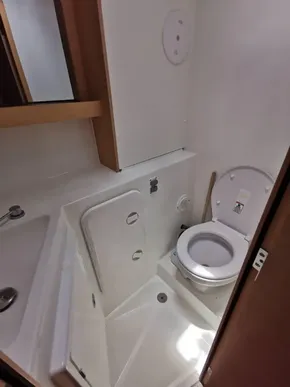 2020 Lagoon 42 yacht bathroom with compact toilet and shower area.