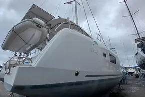 2024 Lagoon 42 catamaran on land, showcasing sleek design and modern features.