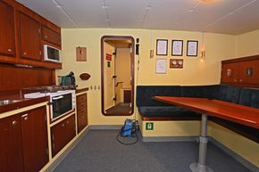 Salon for twelve seated passengers and a small galley