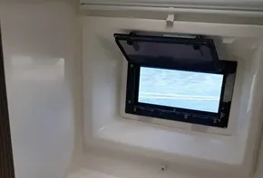 Compact bathroom in a 2017 Leopard 48 yacht with a window and modern fixtures.