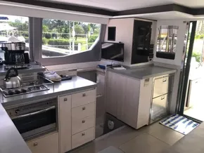 Modern kitchen interior of 2021 Leopard 45 yacht with stainless steel appliances.
