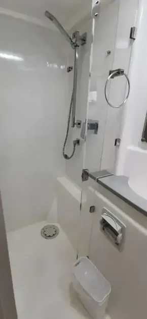 Modern shower area in 2019 Leopard 51 Powercat yacht with glass door and chrome fixtures.