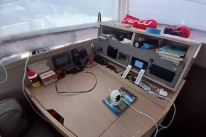 2024 Lagoon 42 yacht interior with navigation equipment and organized workspace.