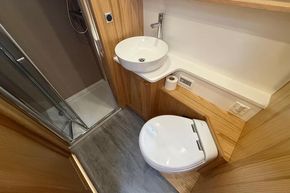 Modern bathroom in 2024 Piper 12c with shower, sink, and toilet.