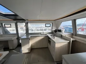 Modern kitchen interior of 2019 Leopard 45 catamaran with panoramic windows and sleek design.