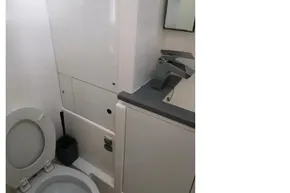 Modern bathroom in a 2020 Leopard 40 yacht, featuring a toilet and sleek sink.