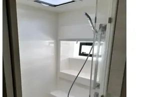 Modern shower area in 2021 Leopard 50 yacht with sleek design and skylight.