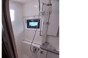 Compact shower area in 2018 Leopard 45 yacht with modern fixtures and window.