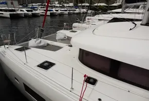 Lagoon 42 catamaran, 2020 model, docked in a marina with other boats.